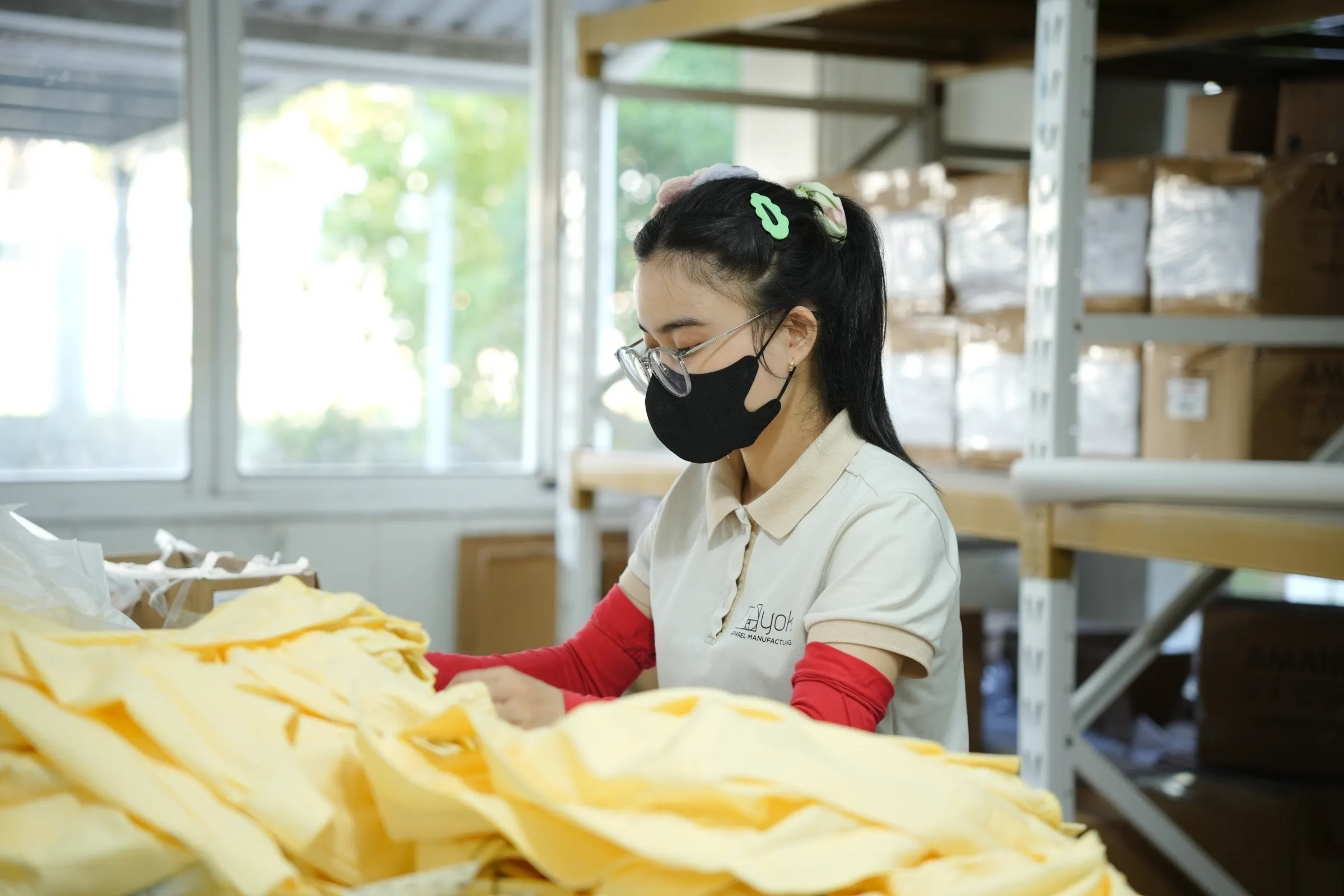 Yoke team member folding finished garments