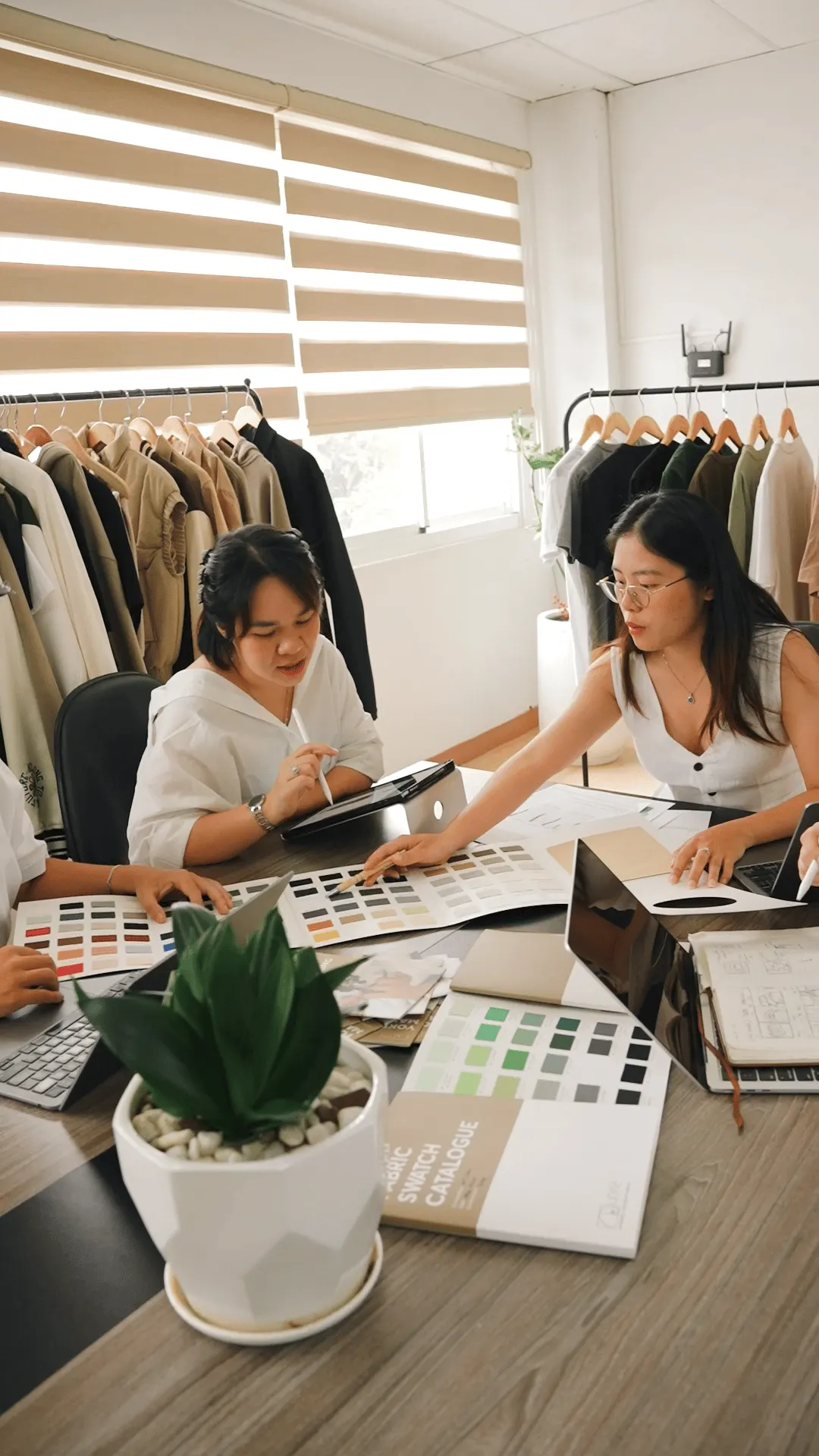 Two Yoke team members reviewing colour swatches and a tablet